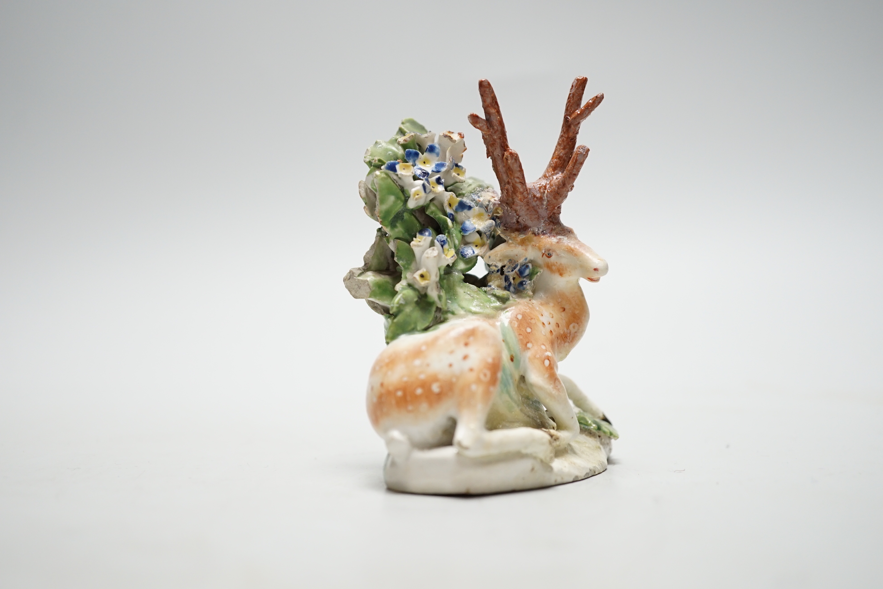 A Derby figure of a recumbent deer and bocage, c.1765, 10cm